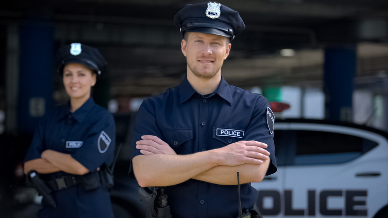 Kind police officers smiling standing